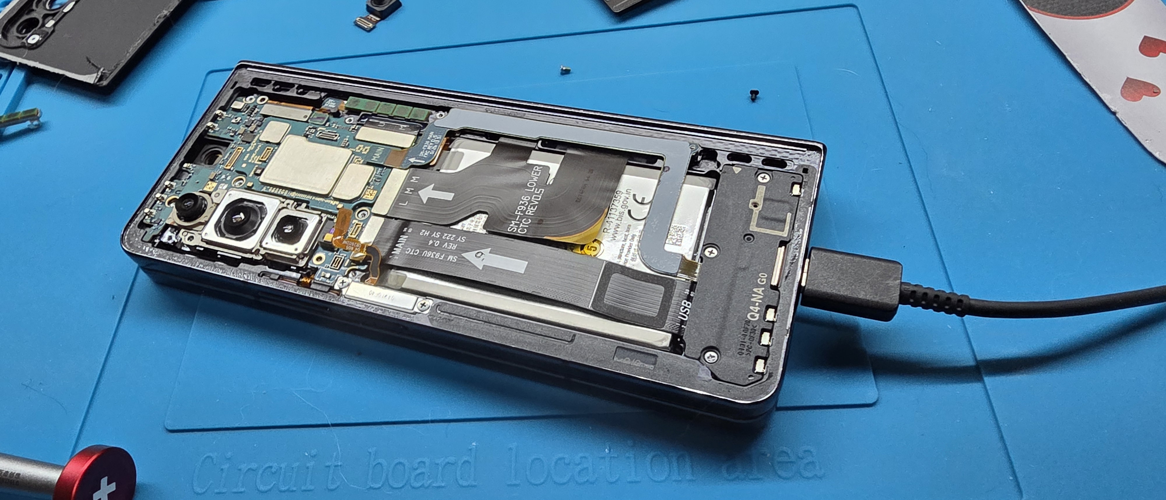 Samsung Fold 4 logic board in chassis on a USB test lead