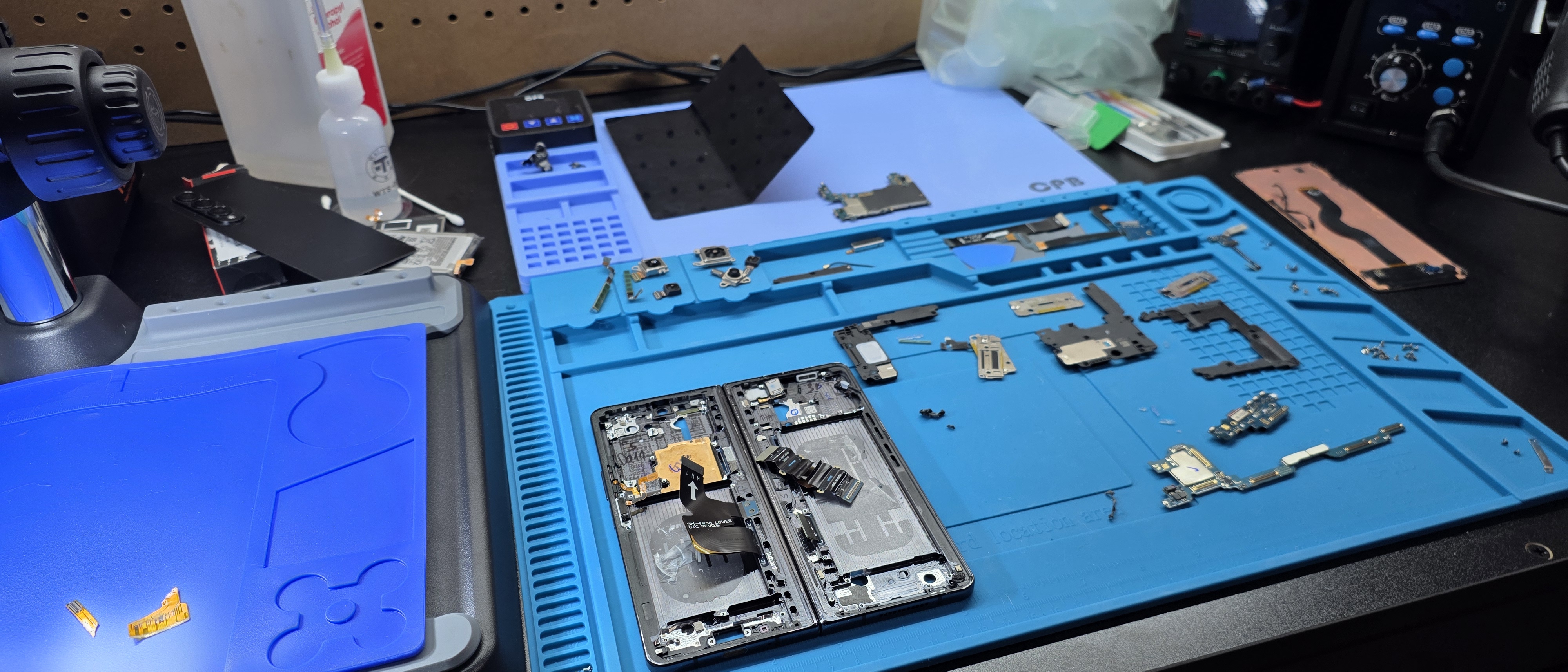 Samsung Galaxy Fold 4 fully disassembled on the Palmdale repair bench