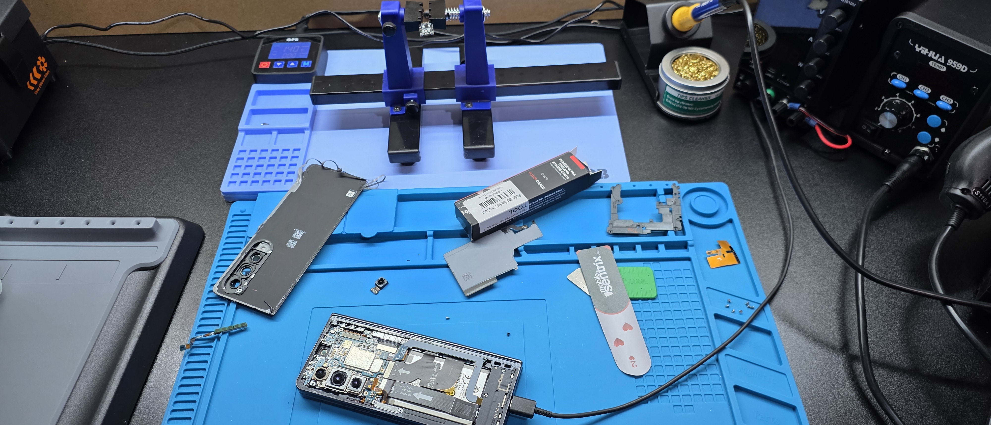 Samsung Fold 4 open on ESD mat next to the Circuit Savages soldering station